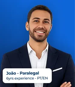Portrait of João, a paralegal with 6 years of experience (PT/EN), wearing a navy suit against a blue background, with a name/title badge showing the text 'João - Paralegal; 6yrs experience - PT/EN'